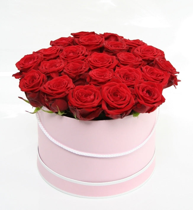 Red roses in a light pink box